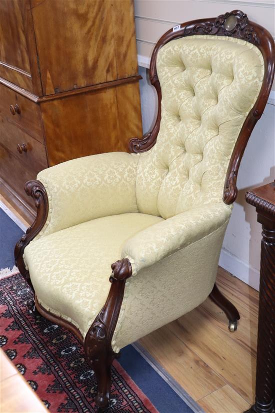 A Victorian mahogany upholstered spoon back armchair